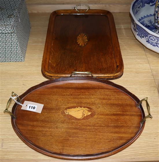 An inlaid mahogany oval tray with brass handles and a similar rectangular tray